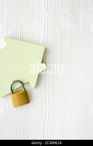 Security concept - lock and house figure - on white desk top-down space of text Stock Photo