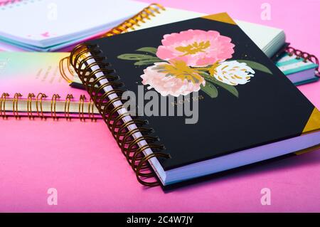 Notebooks with a beautiful design on a pink desk Stock Photo