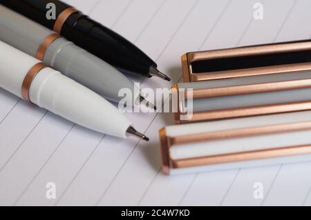 Colorful pens on a sheet of a notebook Stock Photo
