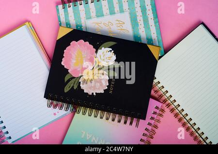 Notebooks with a beautiful design on a pink desk Stock Photo
