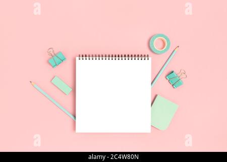 Notepad template with mint stationery on a pink pastel background. Creative mockup. Stock Photo