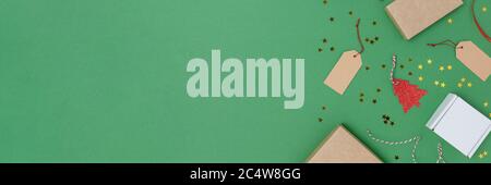Banner with equipment for Christmas gift wrapping on a green background. Festive frame with copy space. Stock Photo