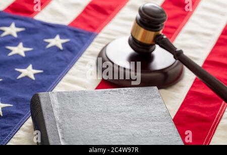 Law case closed. Judge gavel and book on US of America flag background, copy space. Justice in USA concept Stock Photo