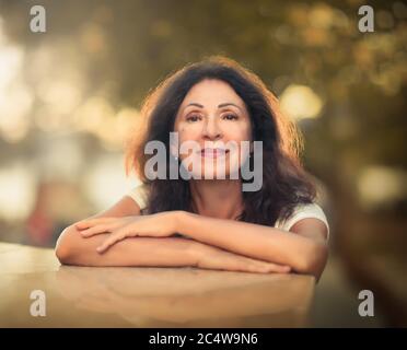 Outdoor portrait of a beautiful smiling senior woman Stock Photo