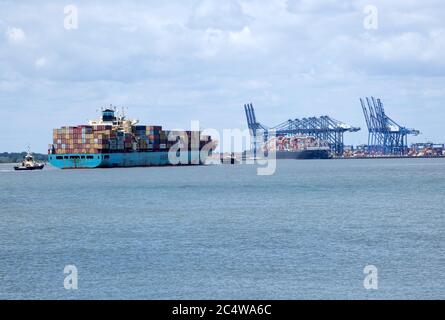 Tugs assisting the arrival of Maersk Utah container ship at Port of Felixstowe, Suffolk, England, UK Stock Photo