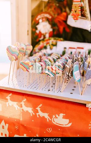 Showcase of the kiosk at the Christmas market - multicolored sucking candy lollipops. Stock Photo
