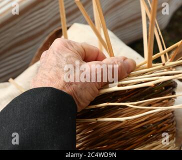 elderly craftsman weaves a wicker basket Stock Photo - Alamy