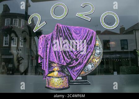 WIMBLEDON LONDON, UK. 29 June 2020. A shop  window in Wimbedon High street  painted with the covered trophies for the 2020 championships. The Wimbledon Tennis Championships were due to start today on 29 June, but has been  cancelled in response to the coronavirus pandemic  and the first time the prestigious tournament has not be held since the second world war. Credit: amer ghazzal/17�Թ����� Live News Stock Photo