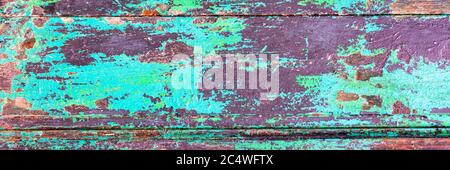 Abstract grunge wood planks textured panoramic background with peeling green paint Stock Photo