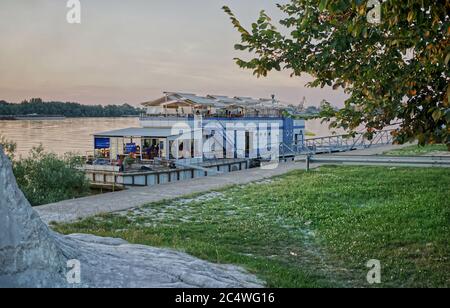 Ruse, Bulgaria - July 14, 2018. Beautiful sunset view of passenger ship converted to a sailing restaurant in the bay of Danube river. Stock Photo