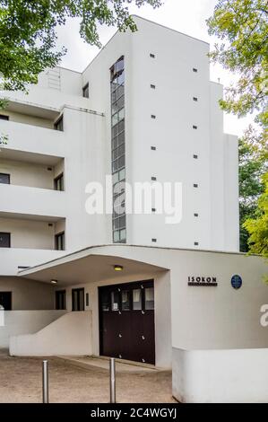 Isokon Flats, also known as Lawn Road Flats, on Lawn Road, Hampstead, London NW3, is a reinforced concrete block of 36 flats (originally 32), designed by Canadian engineer Wells Coates for Molly and Jack Pritchard. The designs for the flats were developed between 1929–1932 and opened on 9 July 1934 as an experiment in minimalist urban living. Most of the 'existenz minimum' flats had tiny kitchens as there was a communal kitchen for the preparation of meals, connected to the residential floors via a dumb waiter. Services, including laundry and shoe-polishing, were provided on site. It has a blu Stock Photo