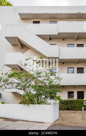 Isokon Flats, also known as Lawn Road Flats, on Lawn Road, Hampstead, London NW3, is a reinforced concrete block of 36 flats (originally 32), designed by Canadian engineer Wells Coates for Molly and Jack Pritchard. The designs for the flats were developed between 1929–1932 and opened on 9 July 1934 as an experiment in minimalist urban living. Most of the 'existenz minimum' flats had tiny kitchens as there was a communal kitchen for the preparation of meals, connected to the residential floors via a dumb waiter. Services, including laundry and shoe-polishing, were provided on site. It has a blu Stock Photo