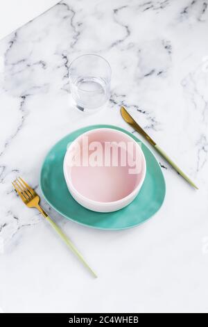 Stylish elegant table setting with ceramic plates on white marble background Stock Photo