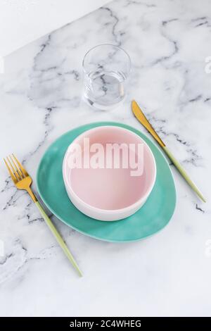 Stylish elegant table setting with ceramic plates on white marble background Stock Photo