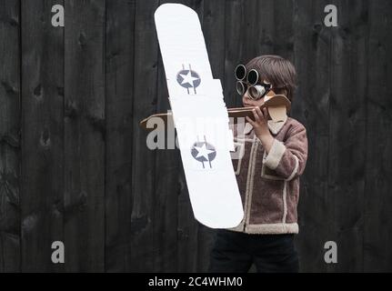 boy is holding a paper plane Stock Photo