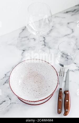 Stylish elegant table setting with ceramic plates on white marble background Stock Photo