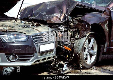 Head-on collision of two cars, close-up of damaged cars at the time of the accident, nobody. Stock Photo