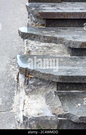 Marble steps in broken condition,  close-up of damages requiring repairs and restoration of the stairs. Stock Photo