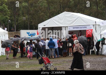 People queue up to have their photo taken with the world’s tallest man Sultan Kosen from Turkey at the Anatolian Turkish Festival in Sydney. Stock Photo