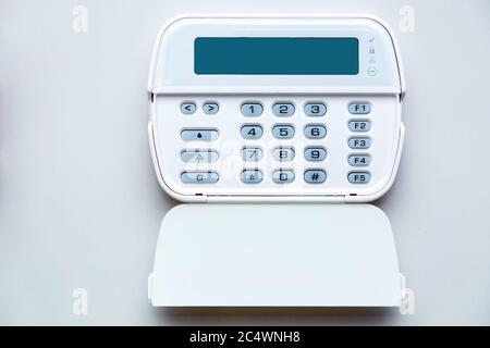 Fire Alarm System Control Center with an open lid for entering a security password and mode settings, front view of a device with a display mounted on Stock Photo