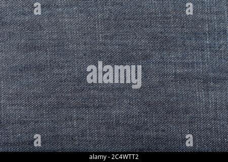 Dark blue denim fabric background. Close up Stock Photo