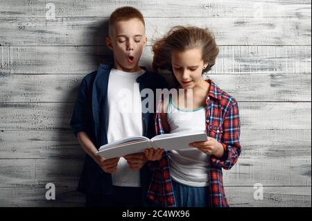 Little boy and girl reding a book against airflow Stock Photo