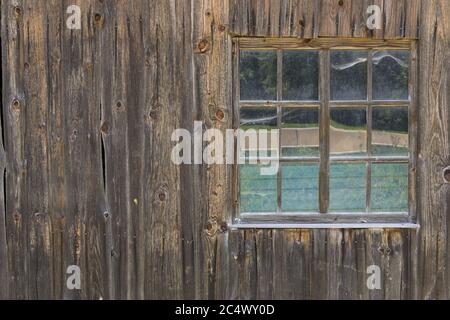 Vintage Window of old farm house barn. Wooden rustic background. Stock Photo