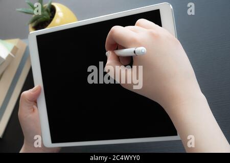 Closeup of female hand using tablet create and design job on the table. Stock Photo