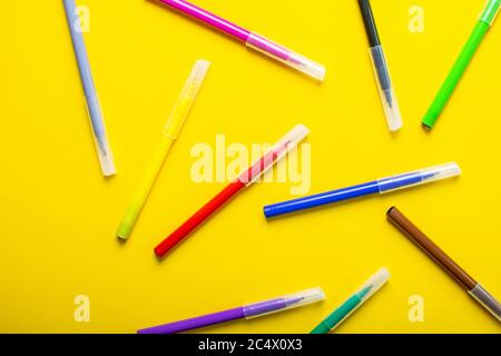Colorful felt-tip pens or markers for drawing on bright yellow background. Stock Photo