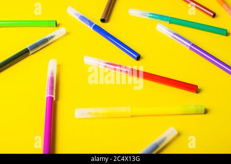 Colorful felt-tip pens or markers for drawing on bright yellow background. Stock Photo