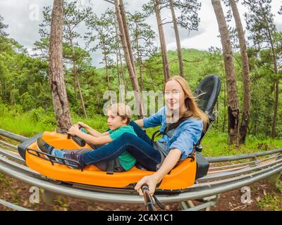 Mother and son on the alpine coaster Stock Photo