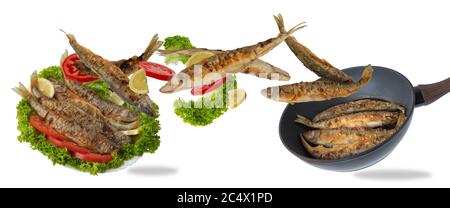 flying fried fish falls into the plate. Food levitation concept. Fried fish with lettuce, lemon and tomatoes. Stock Photo