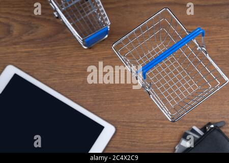 shopping cart and electronic tablet. top view, selective focus. concept of shopping on the Internet Stock Photo