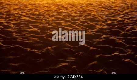 closeup of sand pattern of a beach in the sunset. Stock Photo