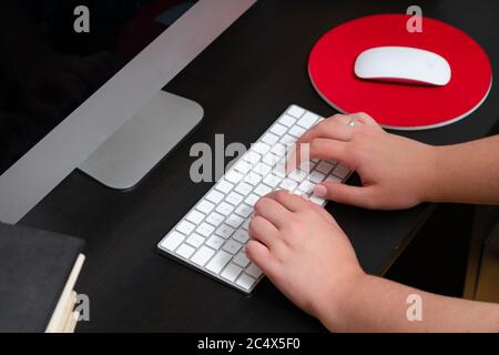 Close up of hands typing keyboard and using mouse at the office. Concept of education and working on computer. Stock Photo