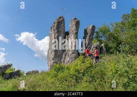 Grandmother and granddaughter riding their mountainbikes in the rocky landscape of Frankonian Switzerland in Bavaria, Germany Stock Photo