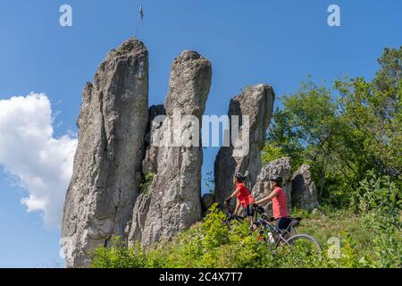 Grandmother and granddaughter riding their mountainbikes in the rocky landscape of Frankonian Switzerland in Bavaria, Germany Stock Photo
