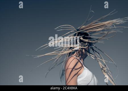 Beautiful woman waving hair with stylish afro braids Stock Photo