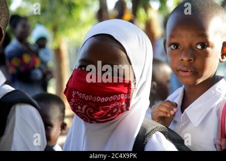 Dar Es Salaam. 29th June, 2020. Students wait to wash their hands before entering classroom at a primary school in Dar es Salaam, Tanzania, on June 29, 2020. Primary and secondary schools in Tanzania reopened on Monday. Credit: Xinhua/Alamy Live News Stock Photo