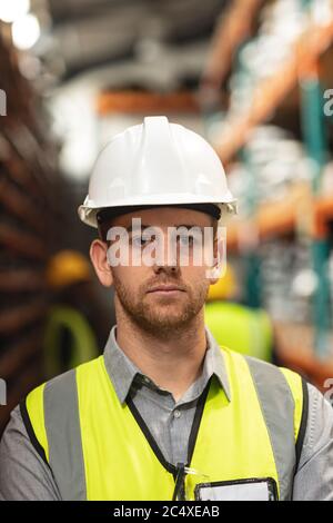 Portrait of a male factory worker wearing a Hi-vis vest and safety helmet Stock Photo