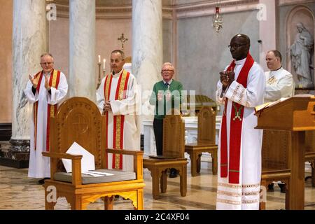 Bishop-elect Martin Hayes (second left) receives applauds as Archbishop Jude Thaddeus Okolo, Apostolic Nuncio to Ireland (right), addresses parishioners as Fr Hayes is appointed as Bishop of Kilmore, at the Cathedral of Saint Patrick and Saint Felim, Cavan. The appointment by Pope Francis was announced as places of worship across Ireland were able to welcome back some members of their congregations for services. Stock Photo