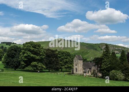 The church of the Holy Cross in the grounds of Ilam Hall, Ilam, Staffordshire, UK; earliest parts date from 11th century Stock Photo