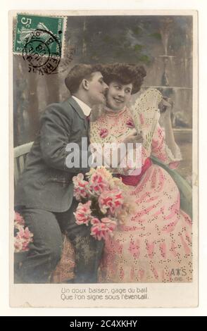 Original early 1900's French sentimental tinted greetings card - two young lovers, a soft kiss, woman with fan, 9 July 1908, France Stock Photo