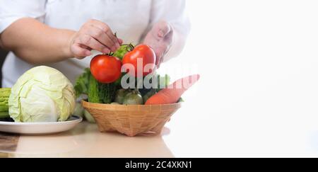 Cook hand holding fresh fruit and vegetable, Healthy diet, Nutrition food as a prescription for good health Stock Photo