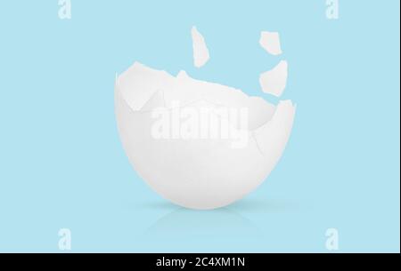 Broken eggshell isolated on blue background Stock Photo