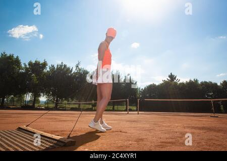 Woman tennis player preparing a tennis court before her match, sport concept Stock Photo