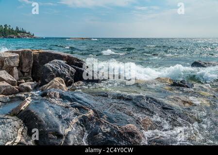 Surf at rocky promontory in Superior Lake Park. Canada Stock Photo