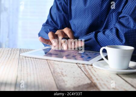 analyzing financial chart on digital tablet at night  Stock Photo