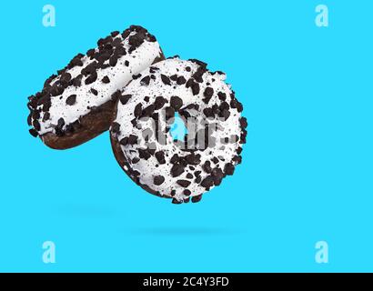 Two chocolate donuts isolated on blue background. Stock Photo