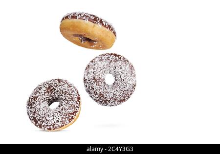 chocolate glazed round donuts with coconut sprinkles isolated on white background. Stock Photo